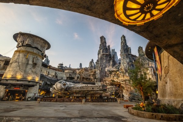 The Millennium Falcon and the rock spires of Batuu in Star Wars: Galaxy&rsquo;s Edge